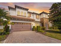 Stunning two-story home with a tile roof, brick driveway, and well-maintained landscaping at 8531 Geddes Loop, Orlando, FL 32836