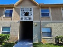 A shot of the building's exterior shows well-manicured landscaping and architectural detail above the entryway at 9917 Sweepstakes Ln # 4, Orlando, FL 32837