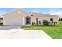 Charming single-story home with a well-manicured lawn, beautiful landscaping and a two car garage at 514 Bristol Cir, Kissimmee, FL 34758