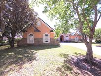Charming home with stone accents, arch windows and well-maintained lawn at 9137 Southern Breeze Dr, Orlando, FL 32836