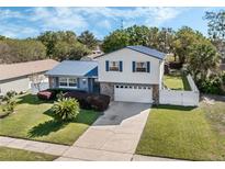 Charming home with a blue metal roof, stone accents, and well-maintained landscaping at 1189 Lazy Hollow Pl, Winter Park, FL 32792