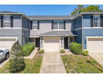 Charming townhome featuring a one-car garage and well-maintained landscaping at 12723 Somerset Oaks St, Orlando, FL 32828