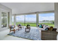 Screened lanai with comfortable seating and a view of the water at 16689 Broadwater Ave, Winter Garden, FL 34787
