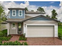 Charming two-story home featuring a two-car garage and landscaped front yard at 17411 Million Lakes Ct, Clermont, FL 34714