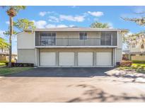 Condominium exterior featuring a four-car garage and screened-in balconies at 4505 Ring Neck Rd # B-1, Orlando, FL 32808