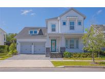 Charming two-story home featuring a two-car garage, covered entry, and a well-manicured lawn at 14691 Walcott Ave, Orlando, FL 32827