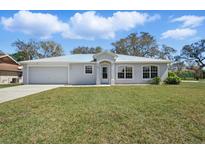 Charming single-story home features a new metal roof, well-manicured lawn, and an attached two-car garage at 1740 Efland Ter, Deltona, FL 32738