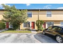 Charming townhouse with a well-maintained front yard and assigned parking spaces at 7417 Wynnewood Sq # 174, Winter Park, FL 32792