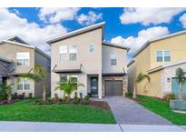 Modern two-story home featuring a stylish design, a paved driveway, and well-manicured landscaping at 830 Sticks, Davenport, FL 33896