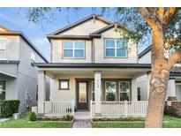 Charming two-story home with a welcoming front porch and manicured lawn in a modern neighborhood at 9149 Grand Island Way, Winter Garden, FL 34787