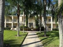 Well-maintained building exterior with landscaping and mature trees at 225 E New Hampshire St # 20, Orlando, FL 32804