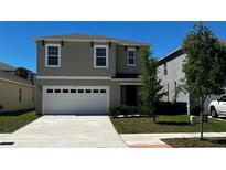 Charming two-story home featuring a two-car garage and well-maintained front lawn in a suburban neighborhood at 2597 Shamrock St, Tavares, FL 32778