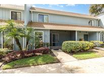 Charming townhouse featuring well-maintained landscaping and a screened-in porch at 40 Moree Loop # 11, Winter Springs, FL 32708