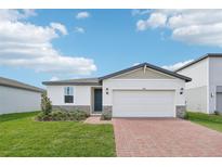 Charming single-story home with a well-manicured lawn and a brick driveway at 4550 Windy Oak Way, St Cloud, FL 34772