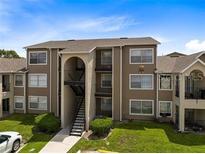 A three-story condo building with outdoor stairs and neat landscaping at 4736 Walden Cir # 15, Orlando, FL 32811