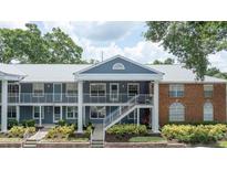 Inviting two-story condo featuring a charming brick accent, landscaped front and private outdoor balcony at 5417 Lake Margaret Dr # 39, Orlando, FL 32812