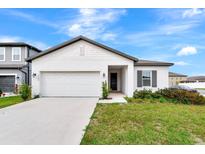 Charming single-Gathering home with a two-car garage, well-maintained lawn, and inviting curb appeal at 5733 Iron Brand Rd, St Cloud, FL 34771