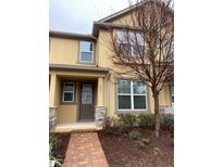 Inviting two-story home with a quaint front garden and a welcoming pathway leading to the front door at 8521 Vedder Ln, Orlando, FL 32832