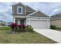 Charming two-story home with a well-manicured lawn and a two car garage at 1902 Presley Pl, Kissimmee, FL 34746