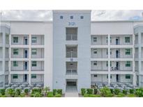 Three-story building with white facade and balconies, with easy access to community a/c units at 3121 Paradox Cir # 307, Kissimmee, FL 34746