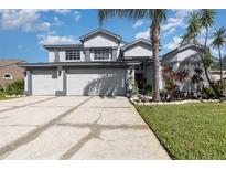 Inviting two-story home with a well-manicured lawn and a three-car garage at 3244 Amaca Cir, Orlando, FL 32837