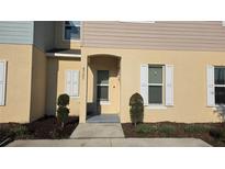 Inviting front entrance with neutral stucco, manicured landscaping, and a covered entryway for convenient access at 4707 Coral Castle Dr, Kissimmee, FL 34746