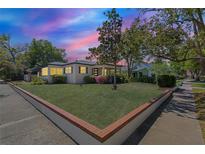 Charming home with a beautifully manicured front yard and colorful landscaping, offering great curb appeal at 602 Rugby St, Orlando, FL 32804
