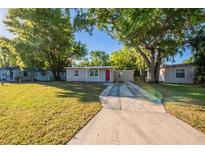 Charming single-story home with a well-manicured lawn and a concrete driveway leading to a red front door at 616 Conroy St, Orlando, FL 32805