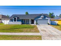 Charming single-story home featuring a well-manicured lawn and a two-car garage at 642 Nardello Dr, Deltona, FL 32725