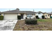 Modest single-Gathering home featuring an attached two-car garage and tidy front yard at 1486 Randolph St, Deltona, FL 32725