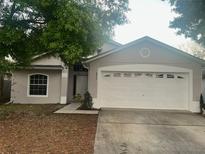 Charming single-story home with a two-car garage and a well-manicured lawn at 2315 Northern Leaf St, Orlando, FL 32817