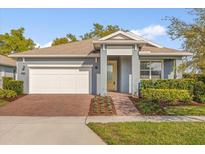 Charming single-story home featuring a brick driveway and well-manicured landscaping at 2413 Park Ridge St, Apopka, FL 32712