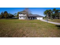 Charming two-story home with landscaped front yard and a two car garage at 36649 Forestdel Dr, Eustis, FL 32736