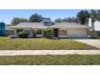 Charming single-story home featuring a well-maintained lawn, brick accents, and an attached two-car garage at 822 Swaying Palm Dr, Apopka, FL 32712