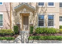 Inviting home exterior with a well-maintained front door, manicured landscaping, and beautiful natural light at 13605 Eridanus Dr, Orlando, FL 32828