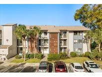 Condo building features beautiful architectural details, lush landscaping, and convenient parking at 15 Escondido Ct # 145, Altamonte Springs, FL 32701