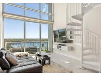 Bright living room with high ceilings, spiral staircase, and panoramic views at 150 E Robinson St # 807, Orlando, FL 32801