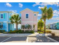 Charming pastel-colored two-story home with tropical landscaping and palm trees in a vibrant community at 2967 Latitude Ln, Kissimmee, FL 34747