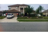 Charming two-story home featuring a well-manicured lawn and festive holiday decorations at 12720 Greco Dr, Orlando, FL 32824