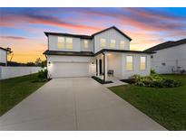 Charming two-story home with a well-manicured lawn and driveway, featuring modern architectural details at 1639 Meadowlark Dr, Deltona, FL 32725