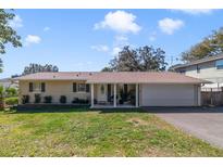 Charming single-story home with a well-manicured lawn and inviting covered front porch at 2136 Topping Pl, Eustis, FL 32726