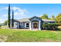 Charming single-story home with manicured lawn and inviting front entrance at 380 Dorset Ave, Deltona, FL 32738