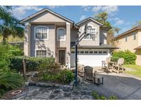 Charming two-story home with landscaped front yard and a driveway with basketball hoop at 452 Opal Ct, Altamonte Springs, FL 32714
