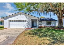 Charming single-story home featuring an attached two-car garage and well-maintained landscaping at 5307 Sandy Hill Dr, Orlando, FL 32821