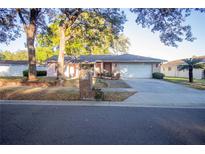 Charming single-story home with a well-manicured lawn and mature trees at 613 Andrew St, Altamonte Springs, FL 32714