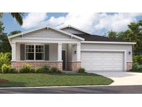Charming single-story home featuring a stone-accented facade, well-manicured lawn, and an attached two-car garage at 917 Pearlwood Loop, Eagle Lake, FL 33839