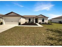 Charming single-story home with a well-maintained lawn, attached garage and front yard landscaping at 1172 Moyle Way, Mascotte, FL 34753