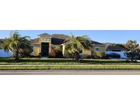 Charming single-story home featuring lush landscaping, a well-manicured lawn, and a welcoming entrance at 2749 Sand Oak Loop, Apopka, FL 32712