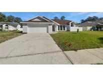 Charming one-story home with a two-car garage, well-maintained lawn, and freshly painted white brick exterior at 3951 Haynes Cir, Casselberry, FL 32707