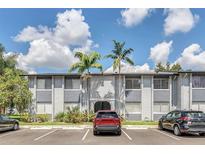 Inviting condo complex with well-maintained landscaping and ample parking on a beautiful, sunny day at 4757 S Texas Ave # 4757D, Orlando, FL 32839